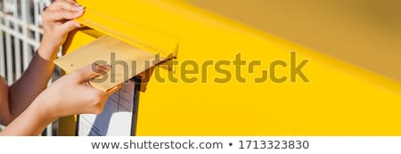 Stockfoto: Person Inserting Envelopes In Mailbox