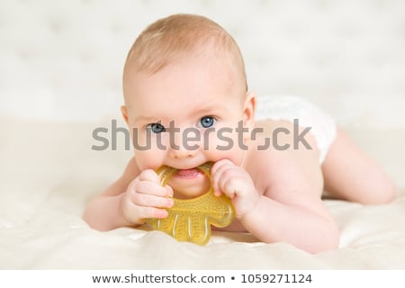 Foto stock: Baby Girl In Diaper Lying With Pacifier On Blanket