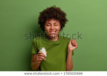 Stockfoto: Woman Clenching Ones Fists With Closed Eyes Against A White Background