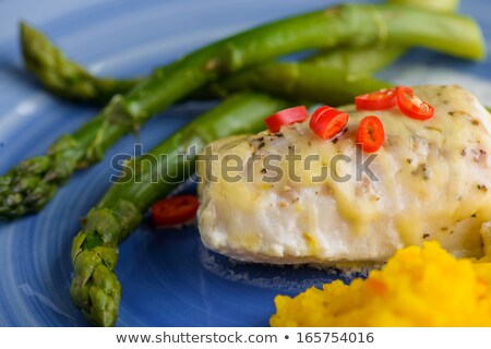 [[stock_photo]]: White Fish With Saffron Rice And Some Cheese On Top And Aspargus