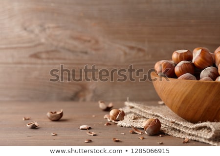 [[stock_photo]]: Heap Of Hazelnuts On A Wooden Table