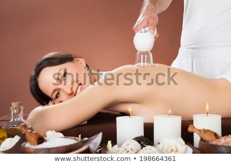 Foto stock: Smiling Woman Receiving Cupping Treatment On Back