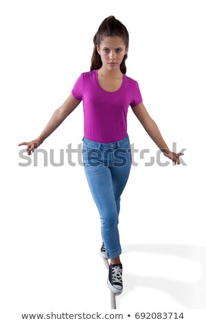 ストックフォト: Girl Walking On A Tight Rope And Trying To Keep Her Balance