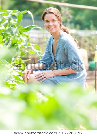Stock fotó: Woman Kneeling Around Plants In Country