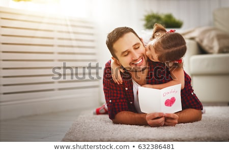 Stock photo: Mother And Daughter Kissing Father