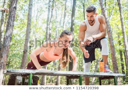 Man And Woman Doing Functional Fitness In Outdoor Gym Foto stock © Kzenon