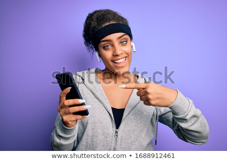 Stock photo: Woman With Smartphone And Earphones Doing Sports