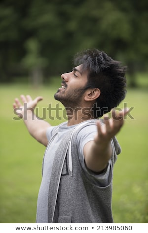 Zdjęcia stock: Man Standing With Arms Raised Outdoors Concept About Freedom Faith And Celebration