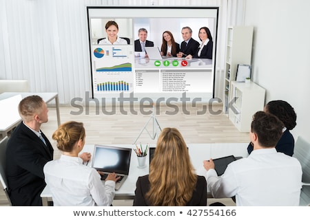 Foto stock: Businesspeople Discussing Graphs Through Videochat