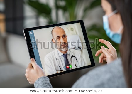 Zdjęcia stock: Man Using A Computer Wearing A Surgical Mask