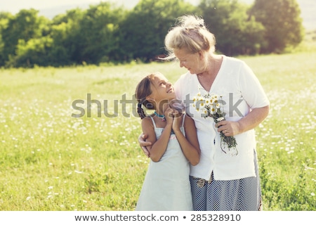 Stock photo: Portrait Of A Girl And Grandmother Gardening