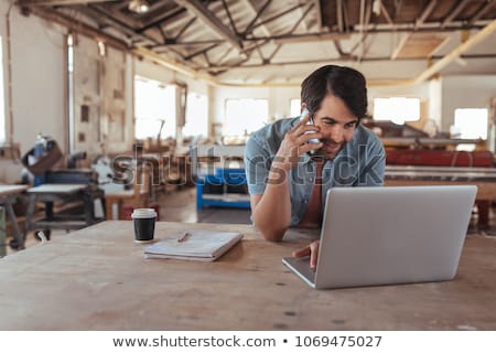 Foto stock: Craftsman Working On His Laptop