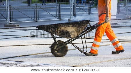 Stockfoto: Construction Worker With A Wheelbarrow