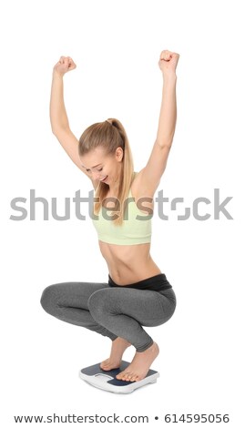 Foto stock: Slim Young Woman Sitting On A Scales Against White Background