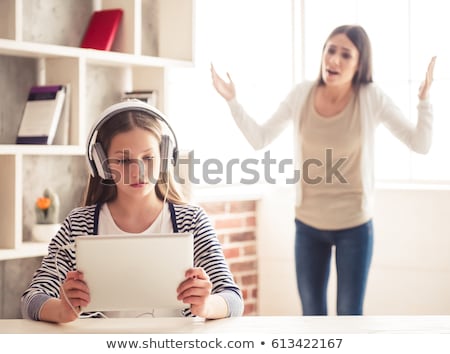 Сток-фото: Teenage Girl With Unhappy Mother In The Background