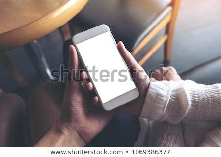 Stock photo: Woman Showing Phone To Boyfriend At Cafe