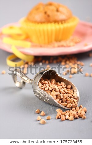 [[stock_photo]]: Metal Shovel With Buckwheat Grain And Muffin