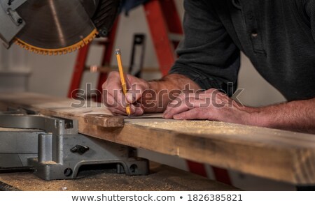 Imagine de stoc: Carpenters With Ruler And Wooden Board At Workshop