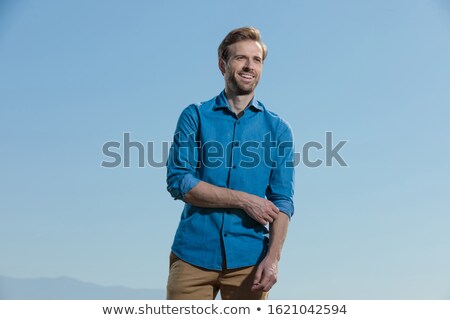Foto stock: Young Casual Man Standing While Fixing His Sleeve