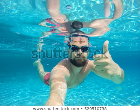 Stockfoto: Beard Man With Glasses Diving In A Blue Clean Water