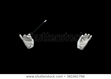 Foto stock: Magician Hands With Magic Wand Showing Trick