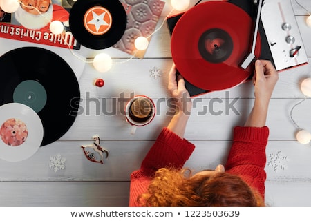 Stock photo: Woman Putting Needle On Vinyl Record On Turntable