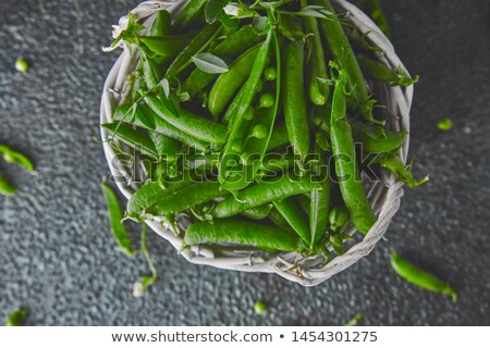 [[stock_photo]]: White Basket With Fresh Green Peas On Black Background