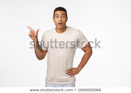 Foto stock: Impressed Surprised Handsome Tanned Man With Tattoo On Arm Wear Casual T Shirt Gasping Amazed As