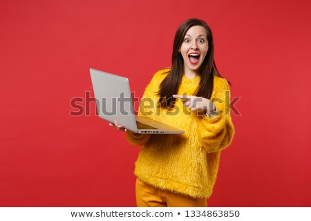 Foto stock: Excited Young Girl Surfing Internet On Laptop