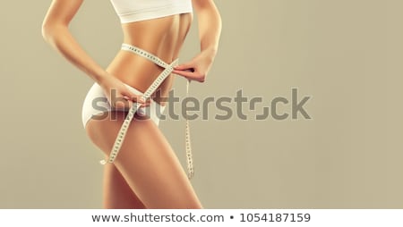 Slim woman measuring her hips. фотография Stock