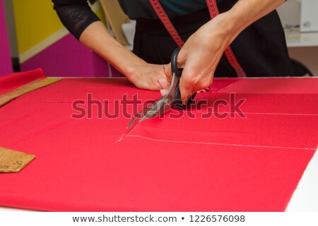 Foto stock: Scissors On Red Fabric