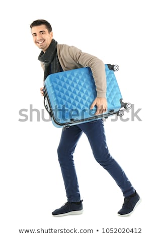 Stock photo: A Young Man Carrying A Suitcase