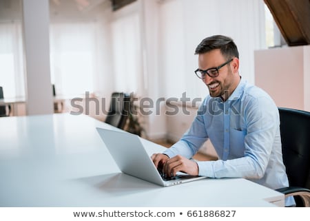 Сток-фото: Smiling Caucasian Businessman Using Laptop