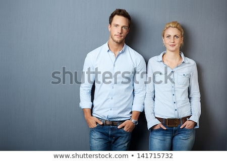 Stok fotoğraf: Woman Looking At The Camera And Man Looking Pensive To A Side