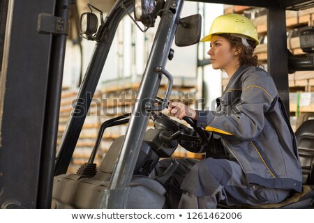 ストックフォト: Supervisor Driving Forklift In Warehouse