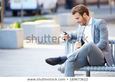 Foto stock: Businessman Drinking Hot Coffee And Using Smartphone