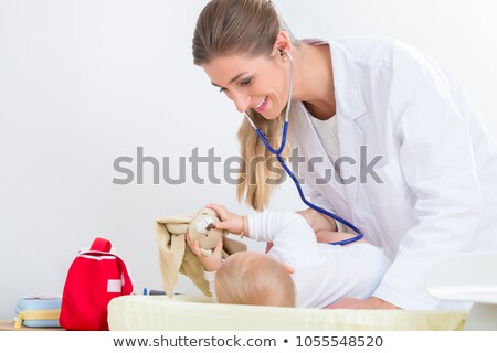 Foto stock: Dedicated Pediatrician Using The Stethoscope During The Check Up