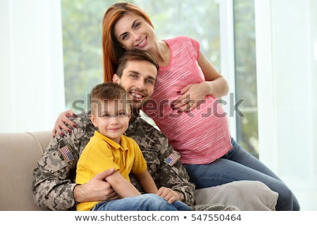 Stok fotoğraf: Soldier Hugging His Pregnant Wife