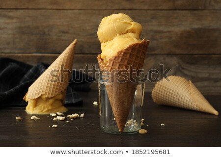 Foto stock: Glass Jar With Wafer Cone For Ice Cream On A Black Background