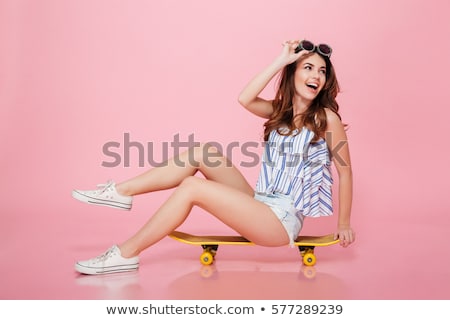 Stok fotoğraf: Portrait Of A Happy Young Woman In Sunglasses Isolated