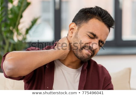 ストックフォト: Unhealthy Indian Man Suffering From Neck Pain