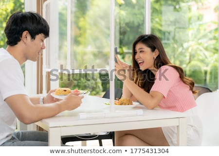 Stock photo: Asian Influencer Food Blogger Take Photo In New Normal Restauran