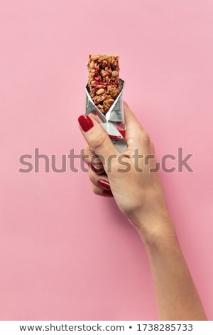 Stock photo: Woman Holding Cereal Bar