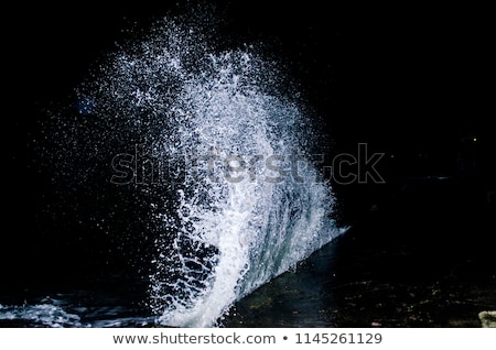 [[stock_photo]]: Water Splashes On Rock With The Ocean In The Background