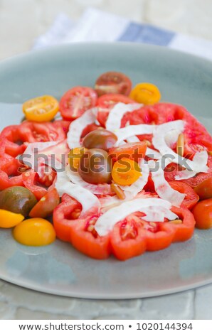 Сток-фото: A Vibrant Healthy Mixed Tomato Mozzarella Pine Nut And Balsamic Vinegar Salad Served On A Rustic