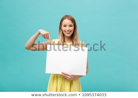 Stockfoto: Pretty Young Woman Holding Empty Blank Board Over Blue Background