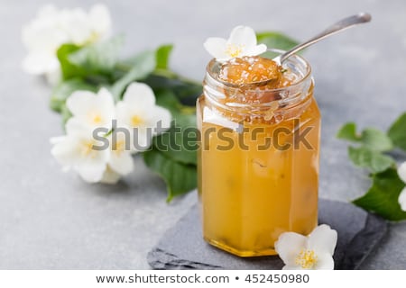 Foto stock: Jasmine Flower Confiture Jam With Fresh Jasmine Flowers Grey Stone Slate Background