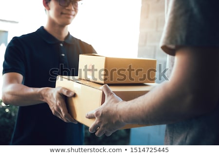 [[stock_photo]]: A Courier Delivers Parcels