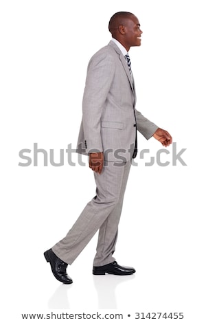 Zdjęcia stock: Side View Of Smiling Elegant Businessman Walking