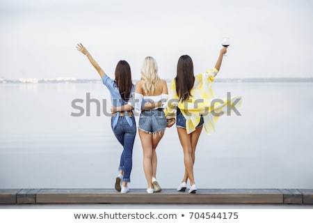 Stok fotoğraf: Back View Image Of Three Smiling Young Women